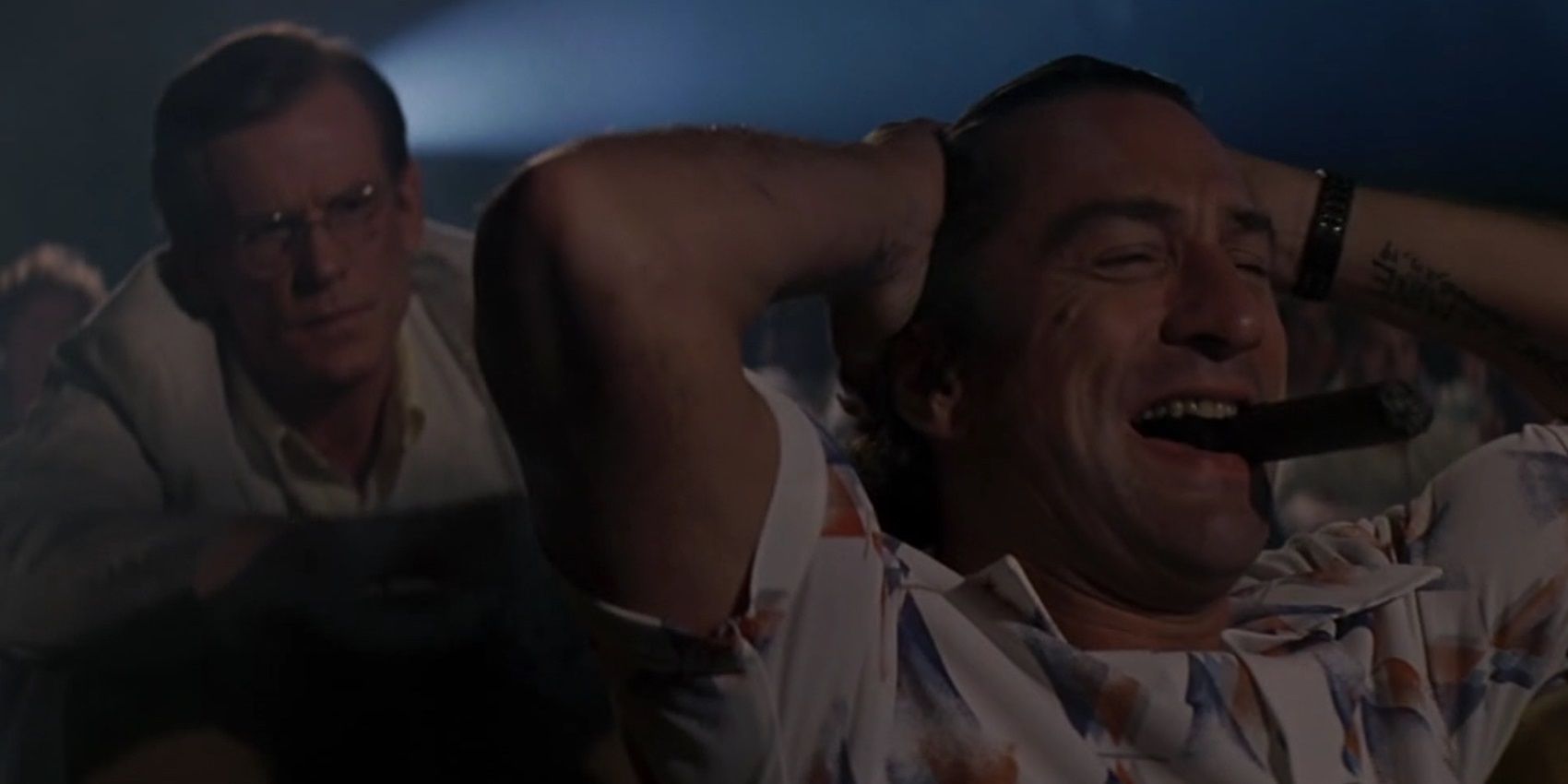 Robert De Niro laughing in a movie theater in Cape Fear