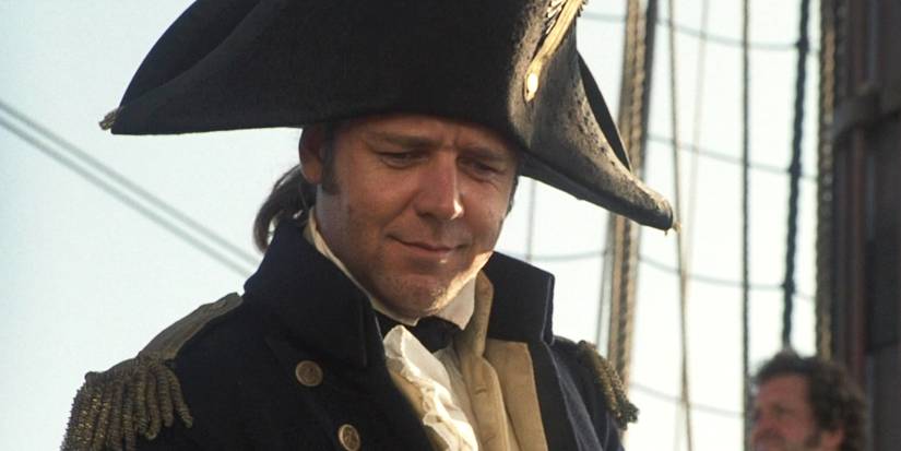 Russell Crowe smiling with his captain's hat on in Master and Commander.