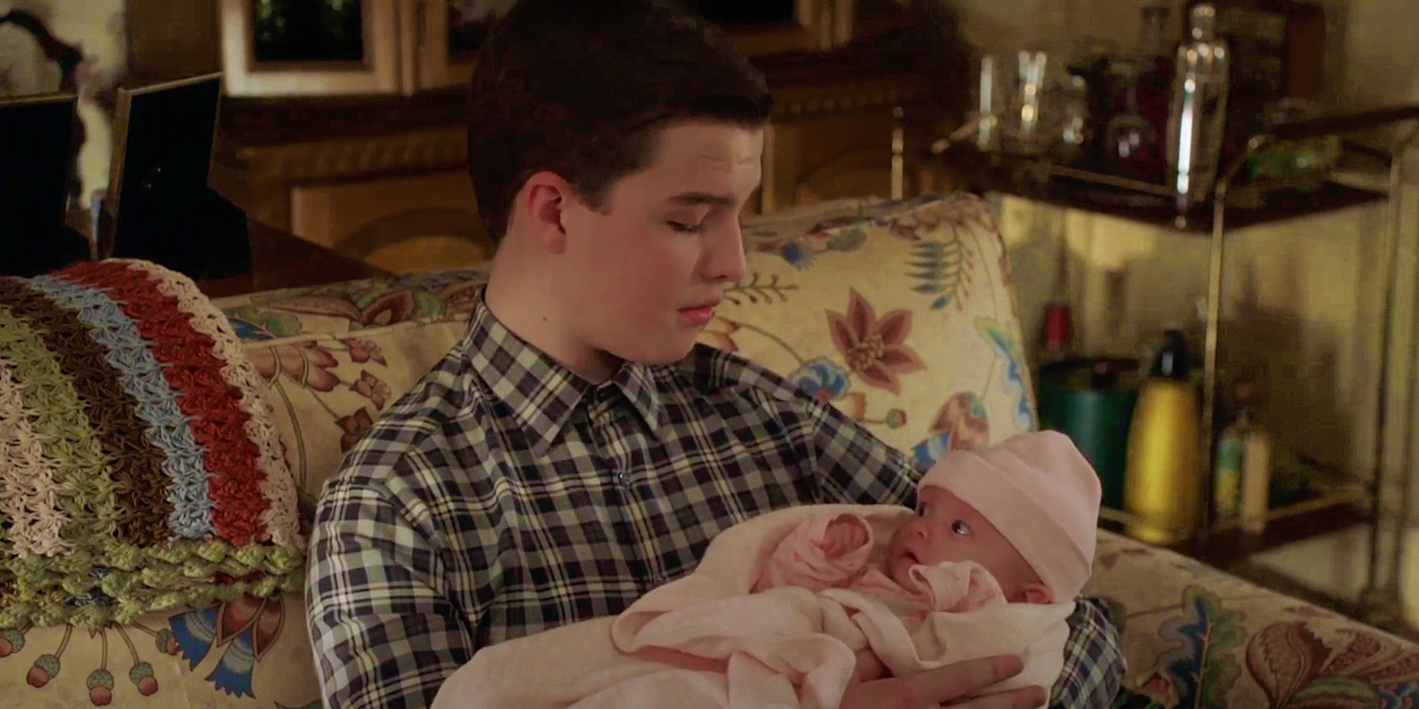 Sheldon holding Baby Constance in Young Sheldon season 6