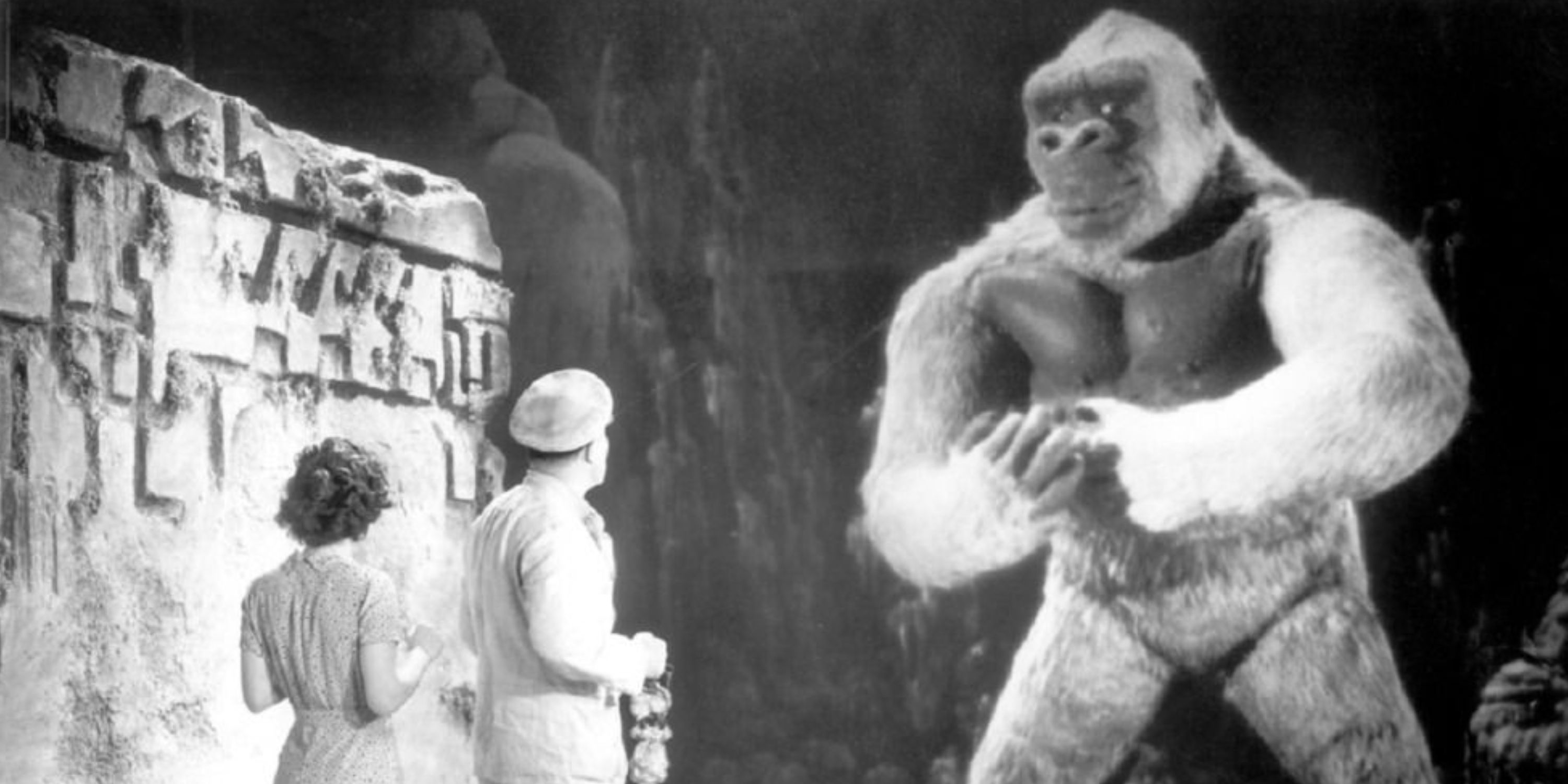 Son Of Kong towers over a man and woman in the 1933 movie