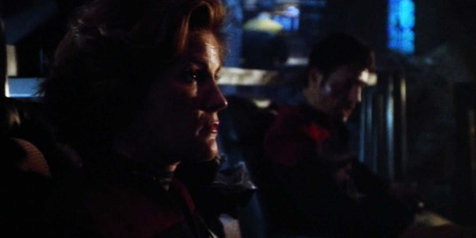 Janeway and Chakotay sit on the destroyed bridge of the USS Voyager fighting back against the Kremin in Star Trek Voyager "Year of Hell Part 1"