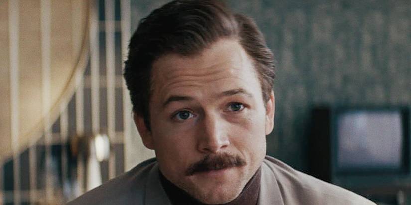 Taron Egerton as Henk looking at something in Tetris