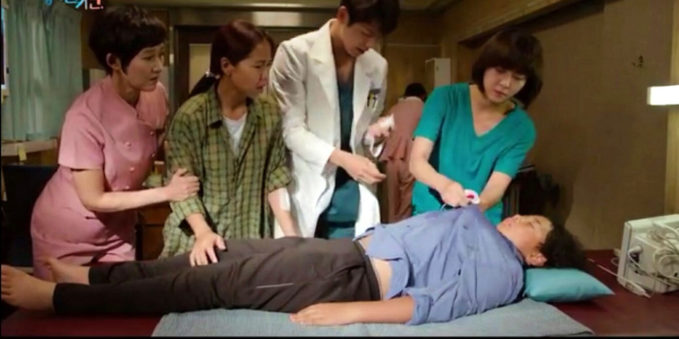 The cast of Hospital Ship taking care of a young man