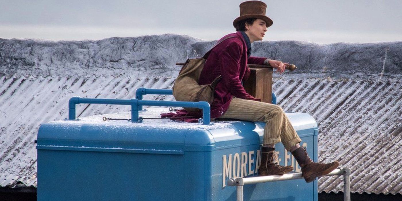 Timothee Chalamet in Wonka sitting on something.