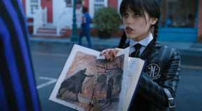 Wednesday (Jenna Ortega) shows an out-of-frame Xavier the drawing of her and Crackstone in Wednesday.