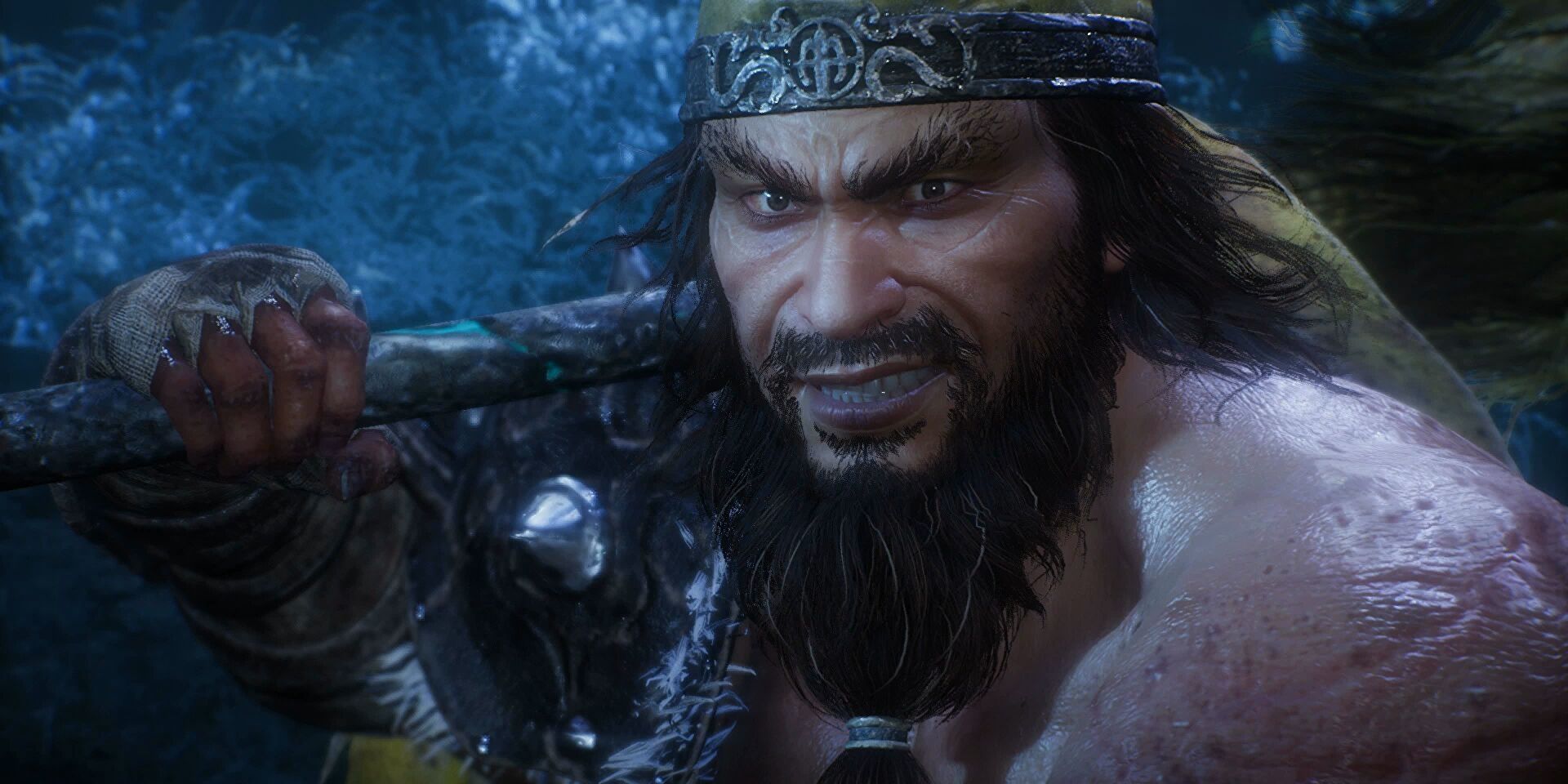 Wo Long: Fallen Dynasty's Zhang Liang boss smirks while supporting his large club-like weapon on his shoulder. He has a large beard, long hair, and wears a metal headband with dragons on it.