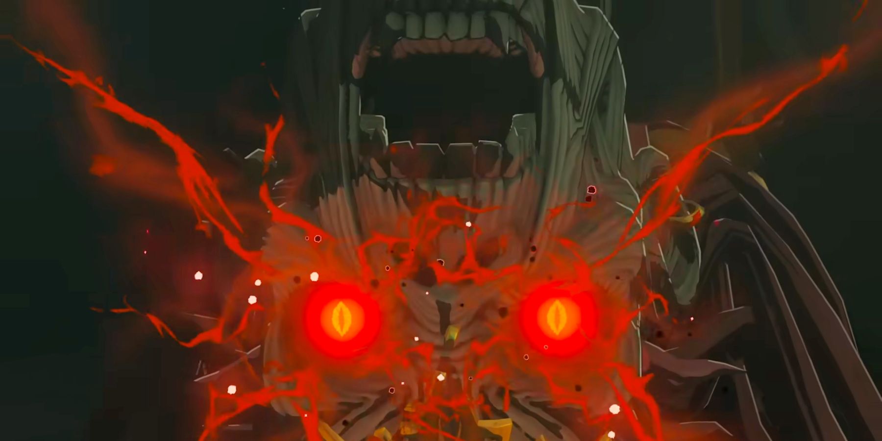 Close-up of Ganondorf's face upside down in Kingdom Tears, eyes glow bright red and give off some kind of energy.
