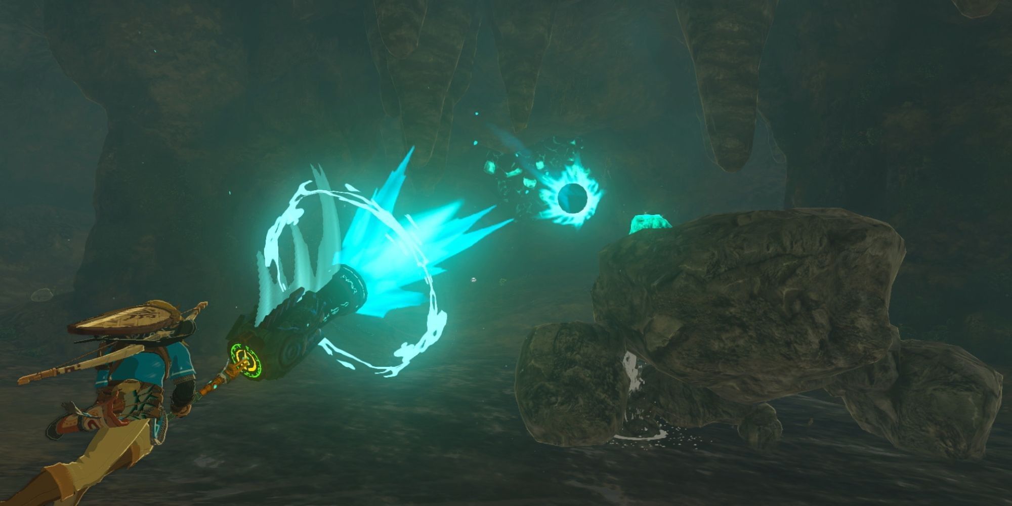 Link fighting a Stone Talus in a cave with a Zonai-style weapon in The Legend of Zelda: Tears of the Kingdom.