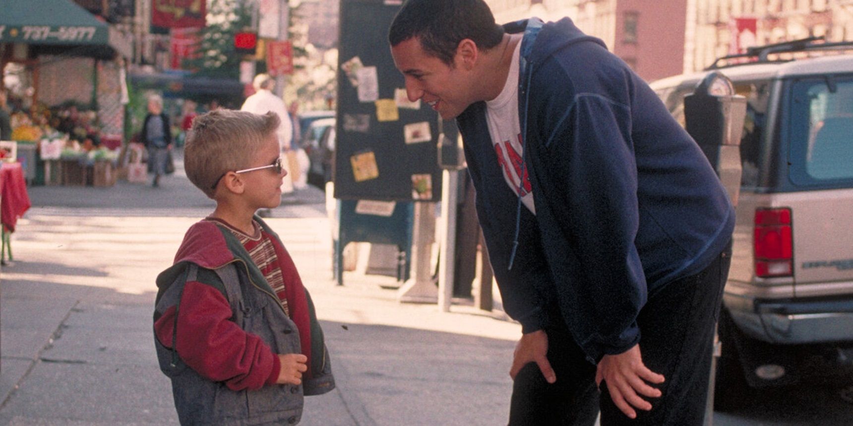 Adam Sandler and Cole Sprouse on the street in Big Daddy