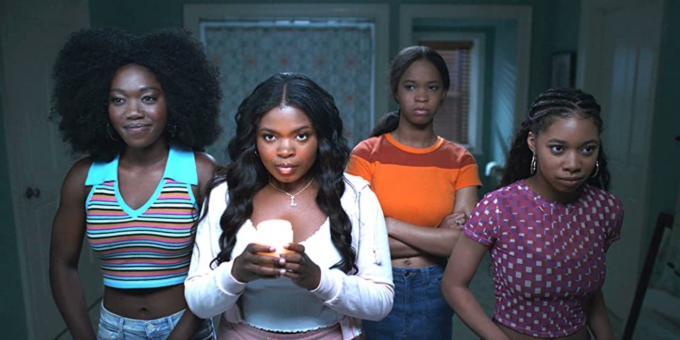 A group of girls hold a candle in front of a mirror from American Horror Stories 