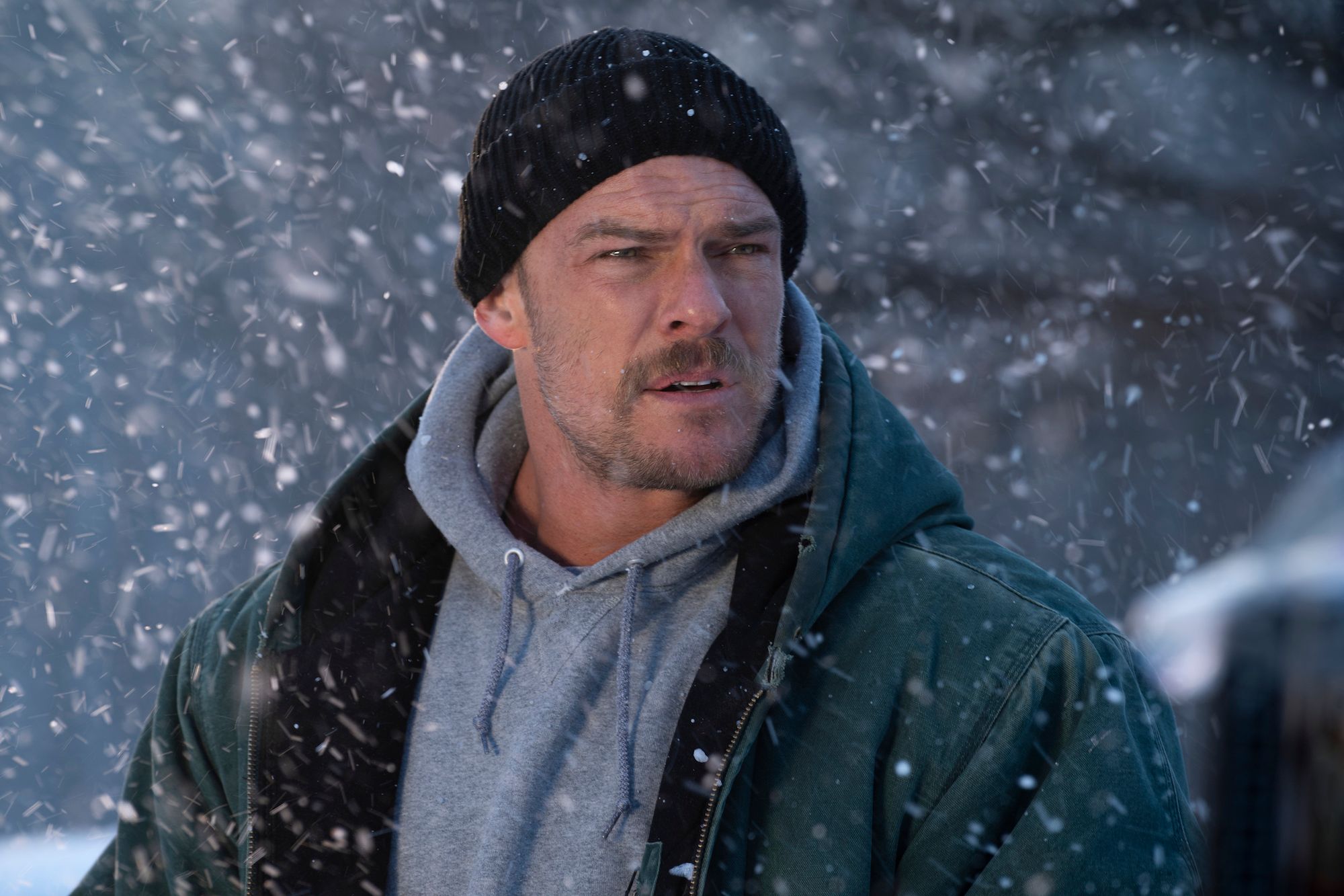 Alan Ritchson as Ed Schmitt in the Snow in Ordinary Angels