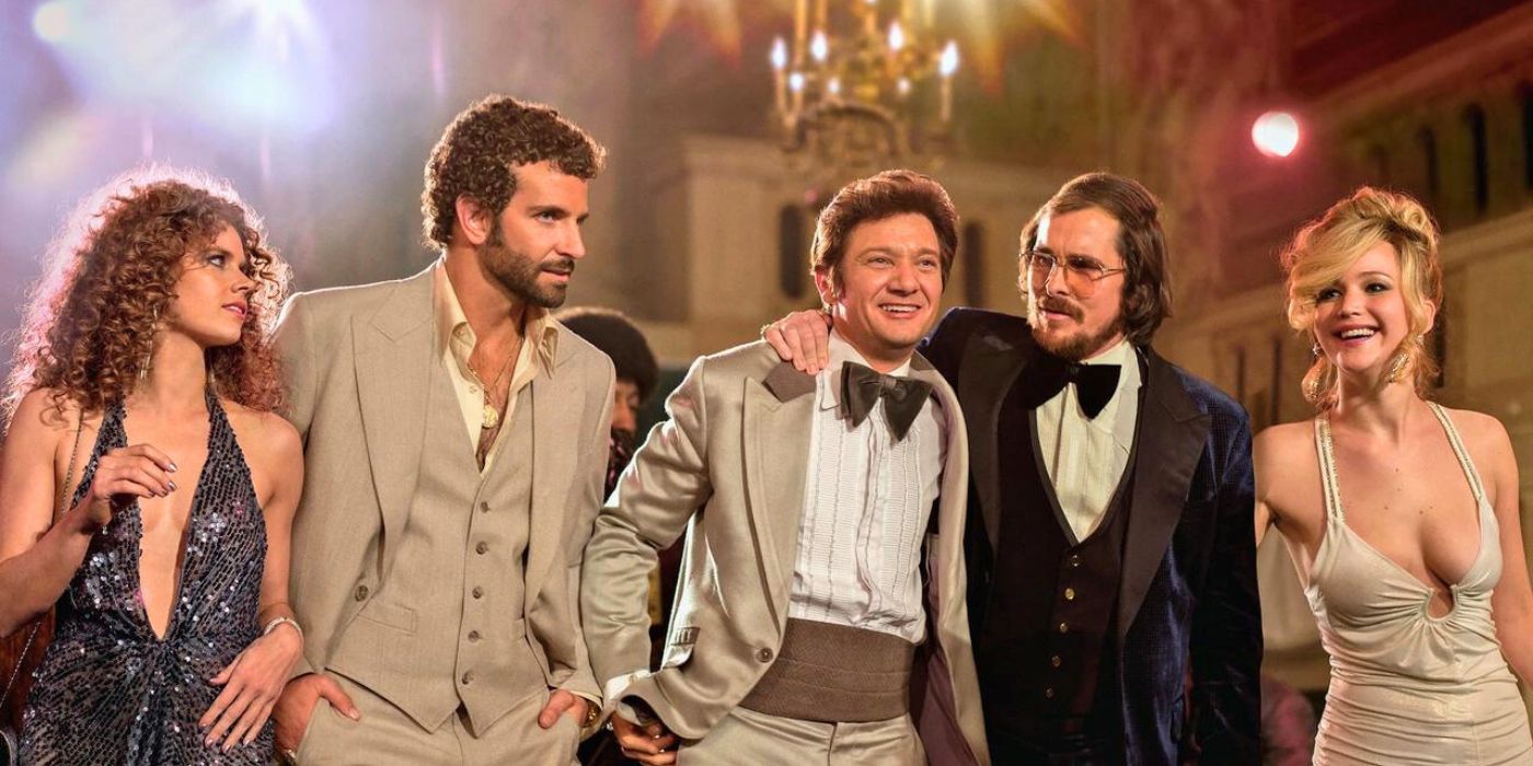 The cast of American Hustle walking together in a line