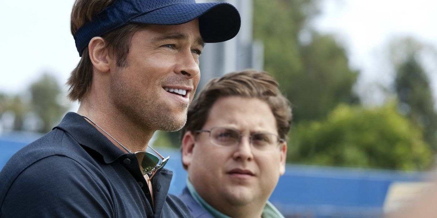 Brad Pitt and Jonah Hill on a baseball field in Moneyball