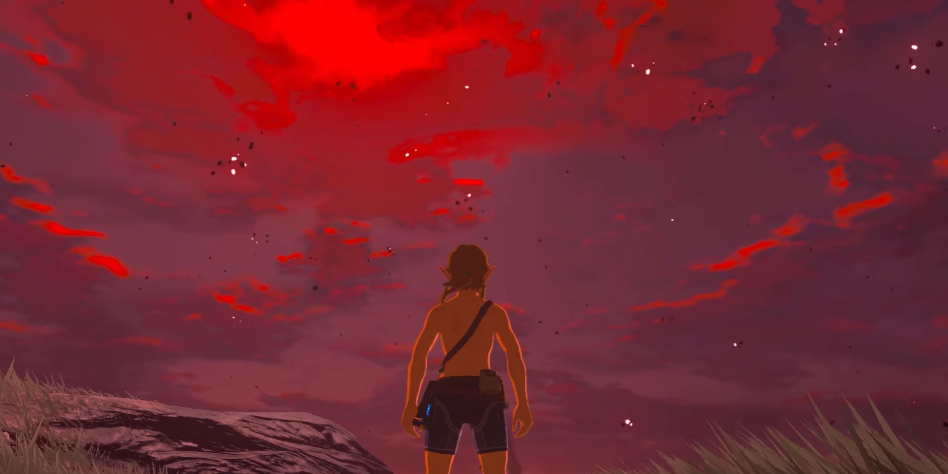 Link menatap langit yang memerah tanpa perlengkapan sebagai bagian dari misi sampingan Breath of the Wild's Under a Red Moon