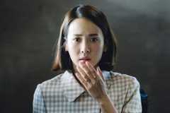 Cho Yeo-jeong Choi Yeon-gyo holds her hand up to her worried face in a scene from Parasite.