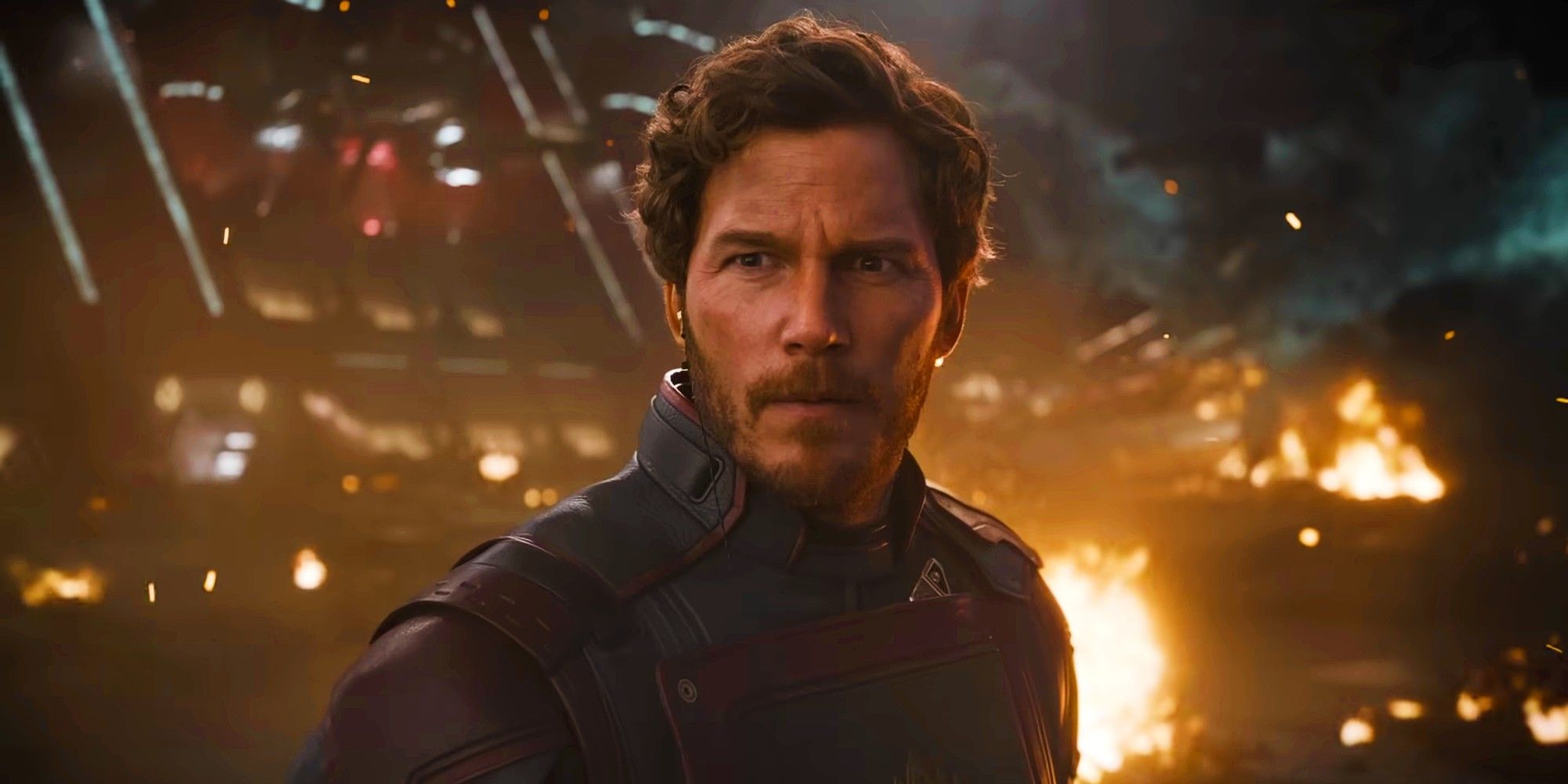 Chris Pratt as Star-Lord standing in front of a fiery background in Guardians of the Galaxy Vol 3