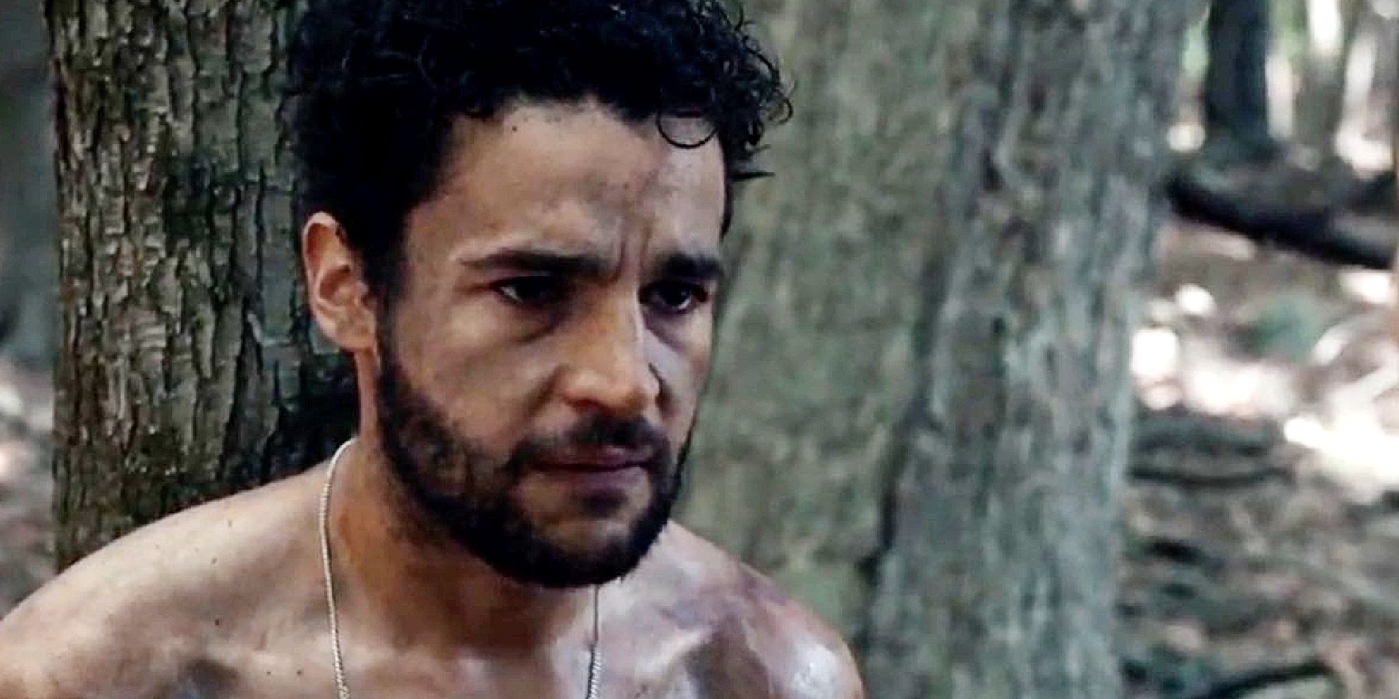 Christopher Abbott leaning against a tree in It Comes At Night