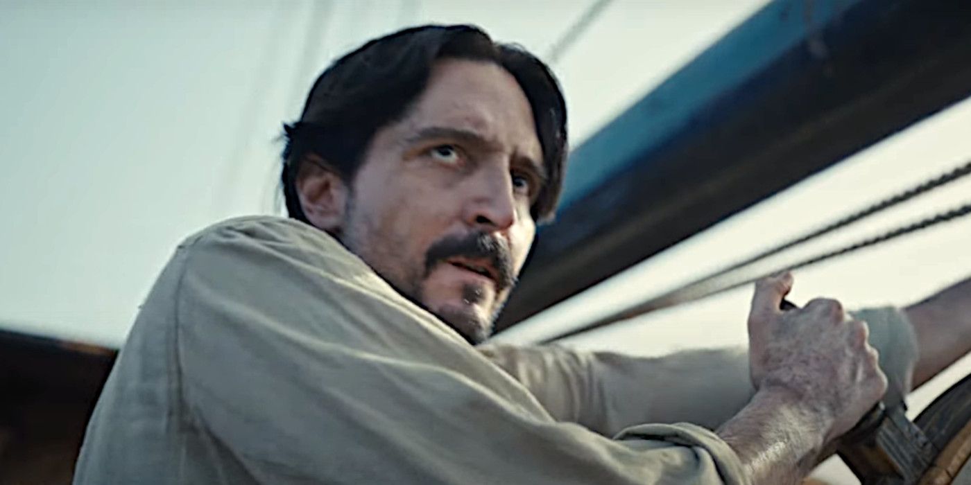 David Dastmalchian in The Last Voyage of the Demeter looking dismayed while heaving on a ship's wheel