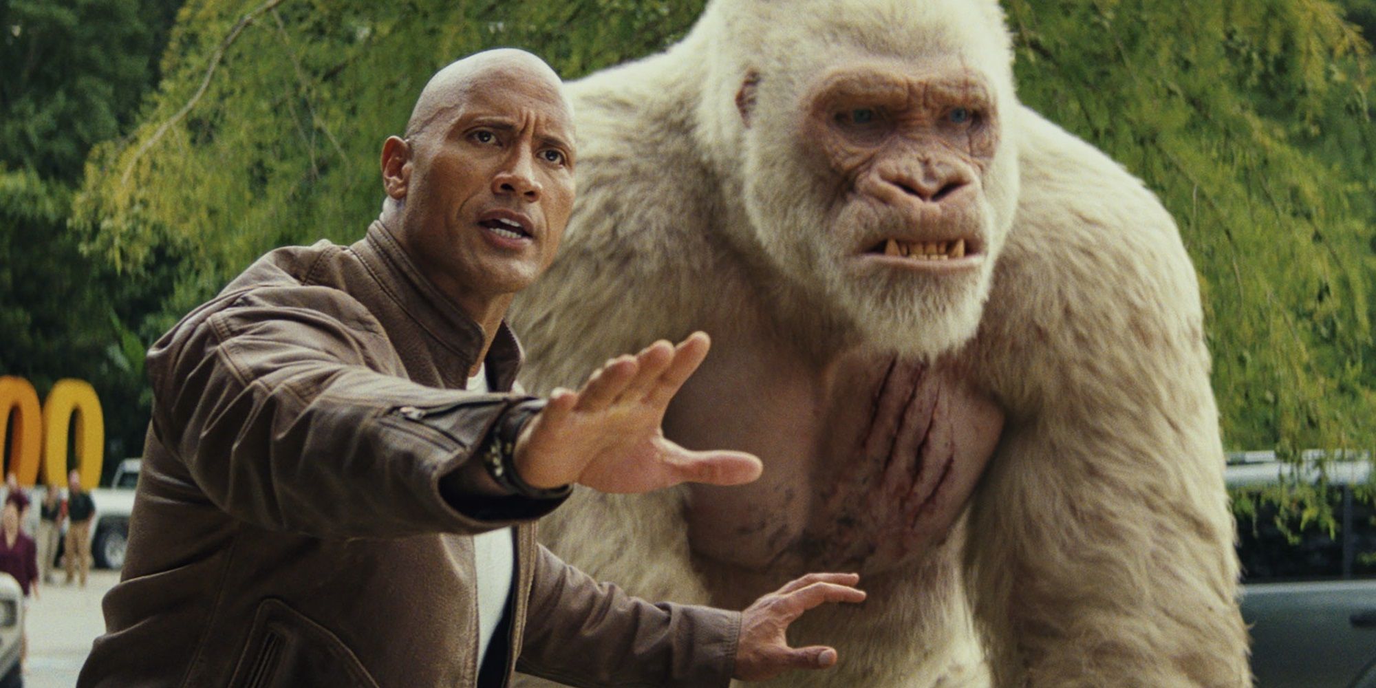 Dwayne Johnson with a giant ape in Rampage