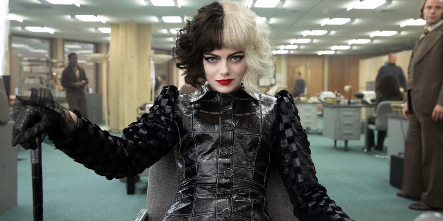 Emma Stone in an office with a cane in Cruella