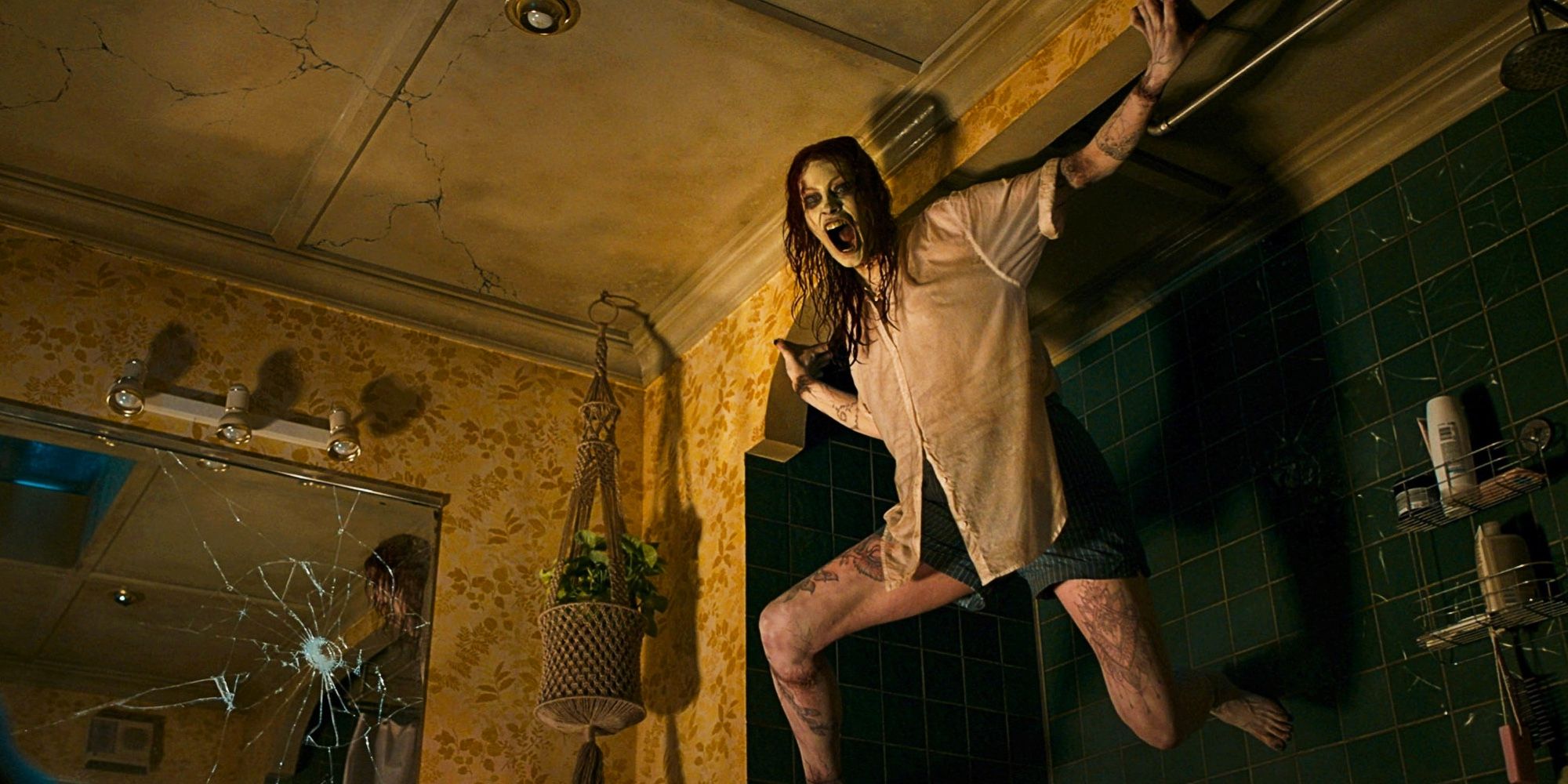 Alyssa Sutherland as Deadite Ellie screaming on a wall in Evil Dead Rise