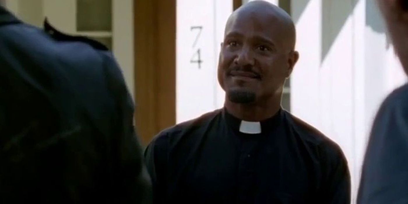 Father Gabriel smiling at Negan in Walking Dead.
