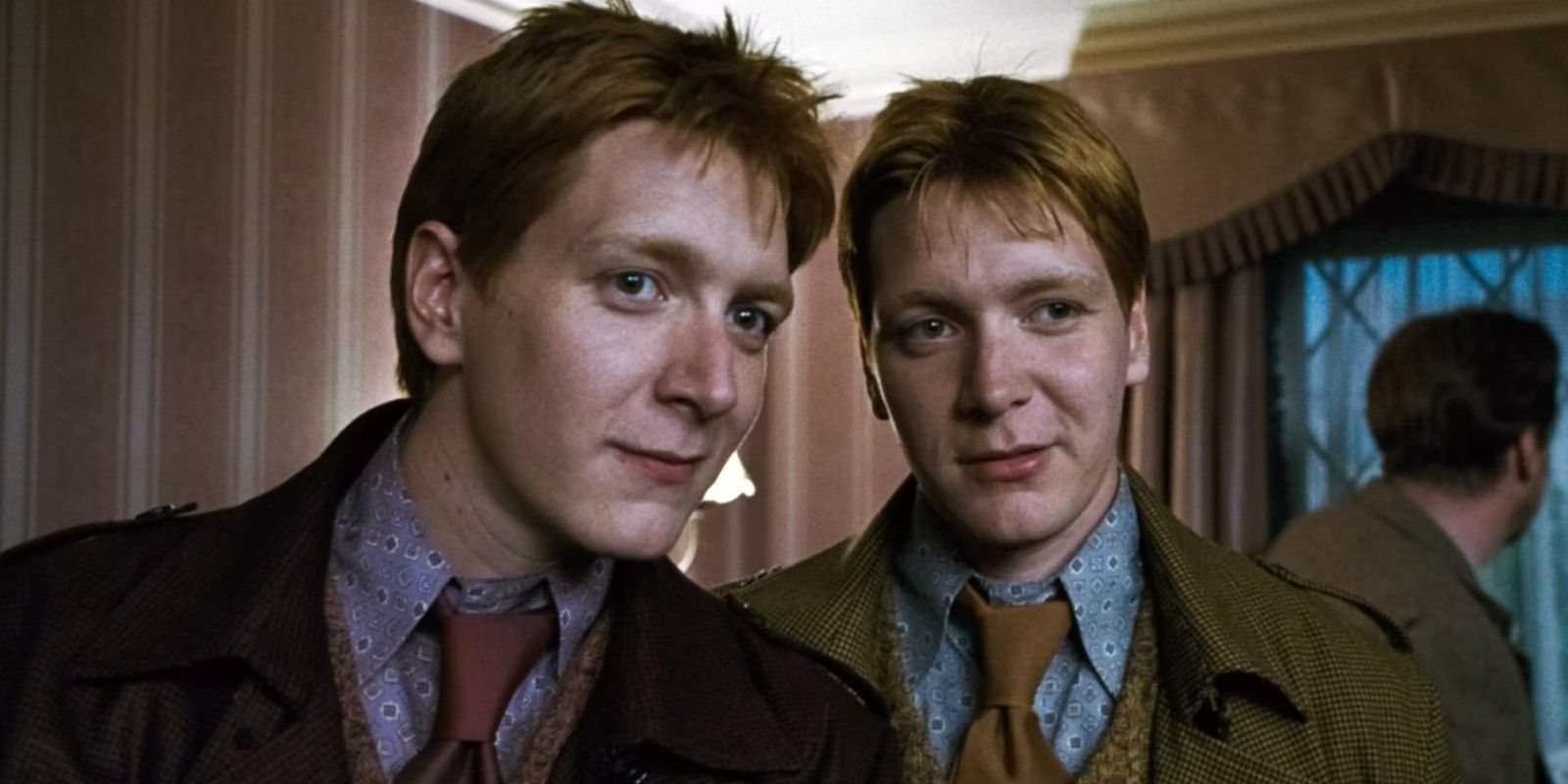 Fred and George Weasley looking at someone in Harry Potter and the Deathly Hallows Part 1.