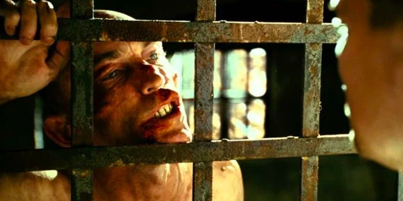 George Noyce leaning against prison bars in Shutter Island