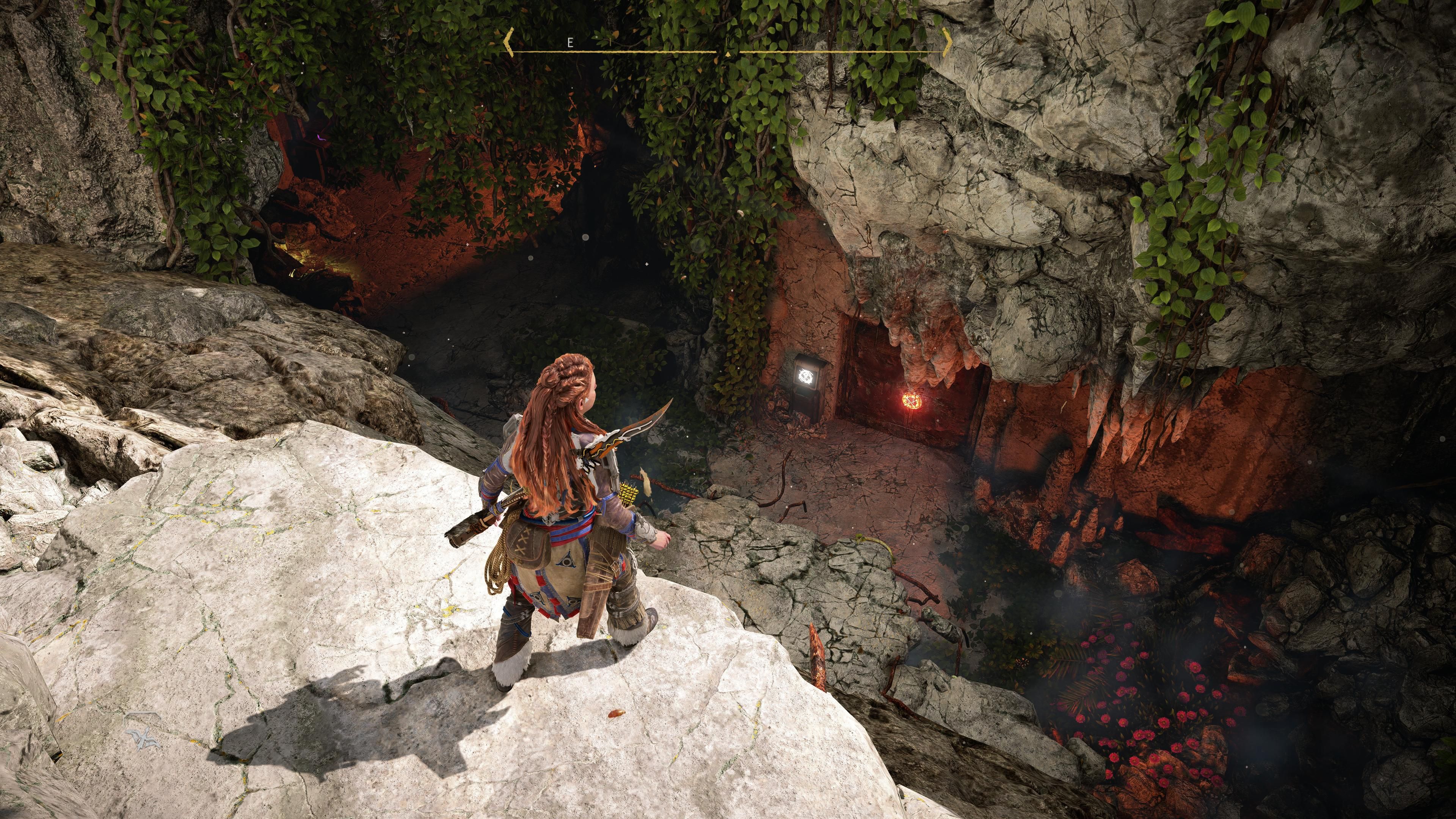 Horizon Forbidden West Burning Shores Aloy Looking Down Into Relic Ruin Cavern