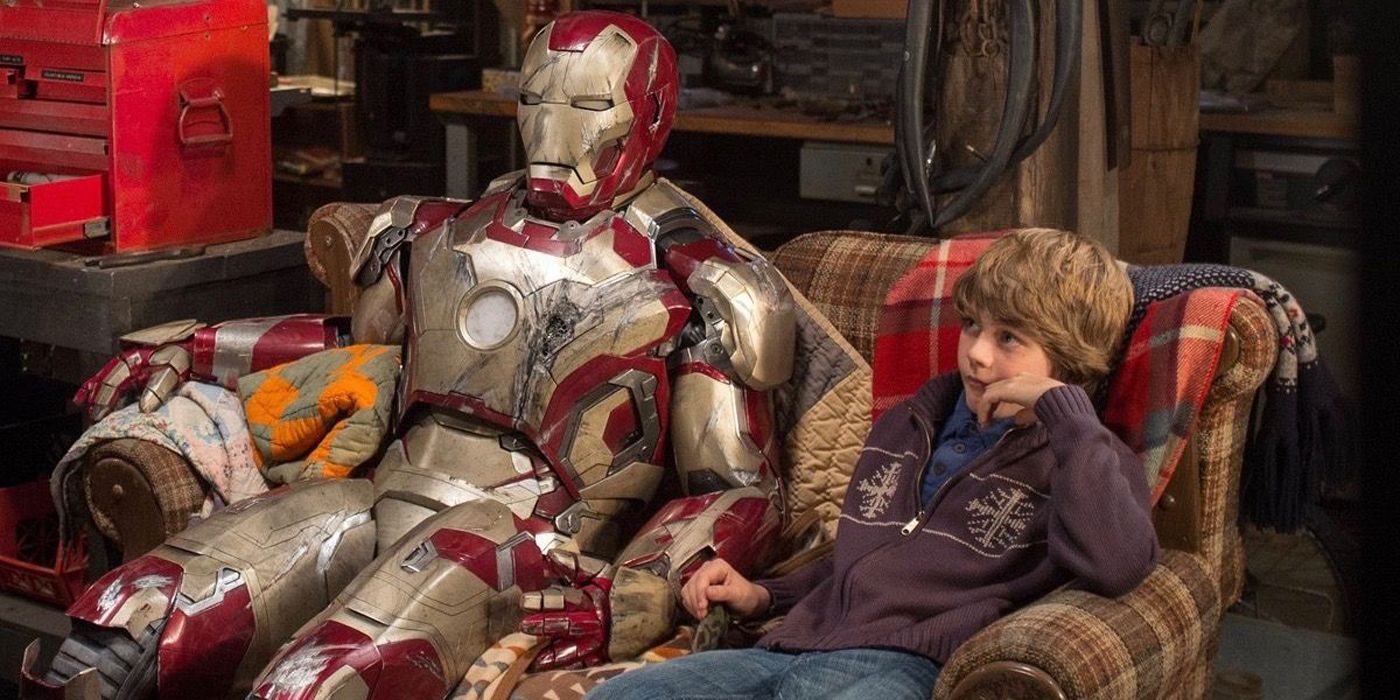 Ty Simpkin's Harley Keener sits on a couch next to damaged Iron Man armor in Iron Man 3