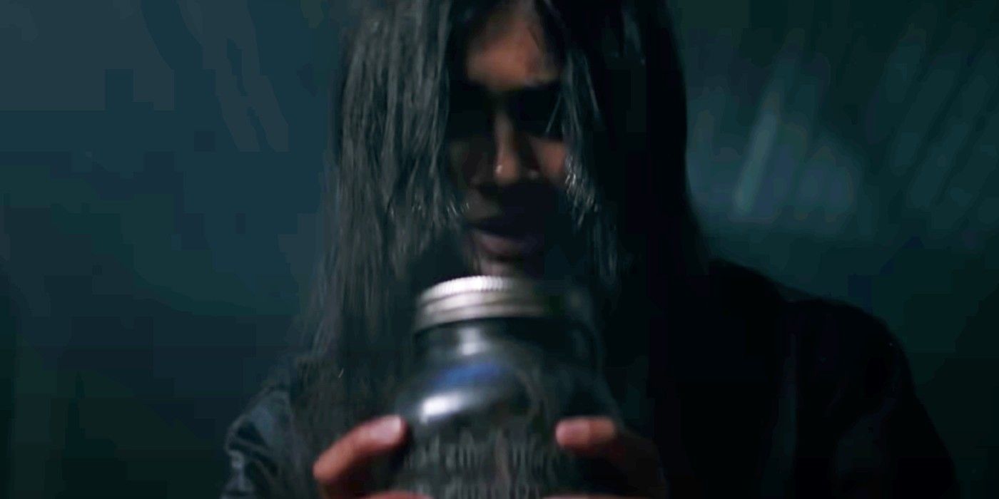 Mohana Krishnan holding a mason jar in It Lives Inside