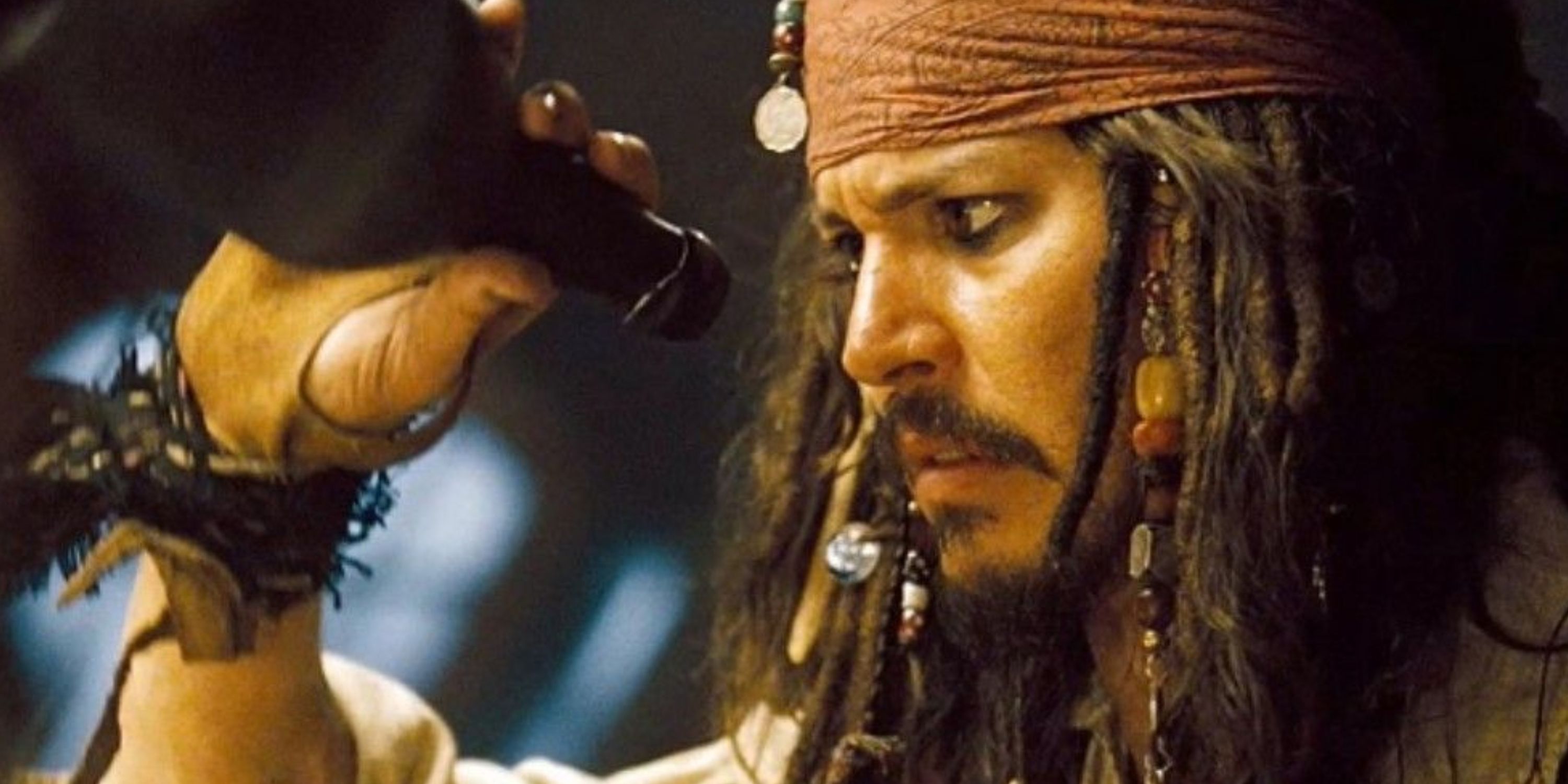 Jack Sparrow looking at a bottle of rum