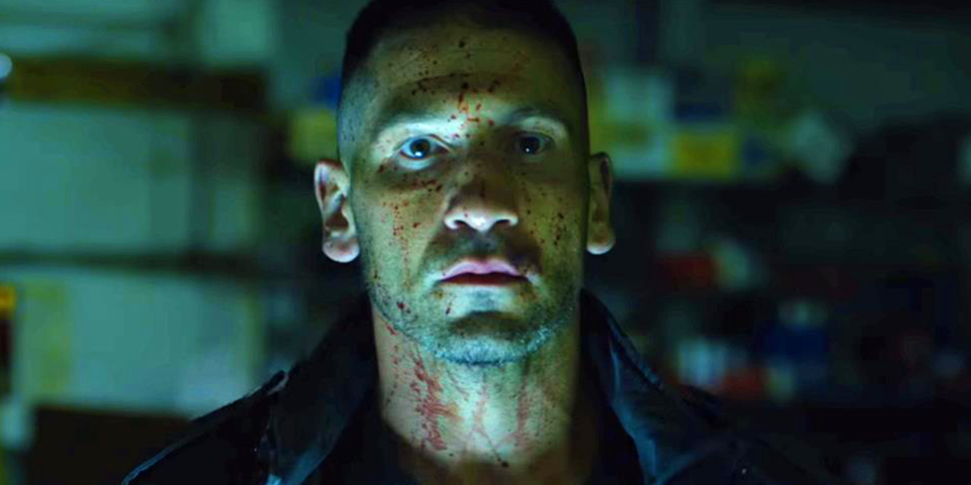 Jon Bernthal's Frank Castle with blood splattered across his face in a scene from Netflix's The Punisher series.