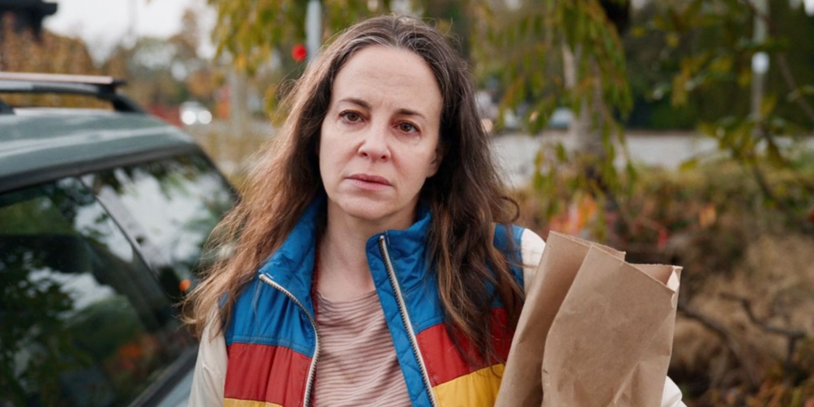 Maria Dizzia as Sandra Nears looking tired while carrying a bag in School Spirits