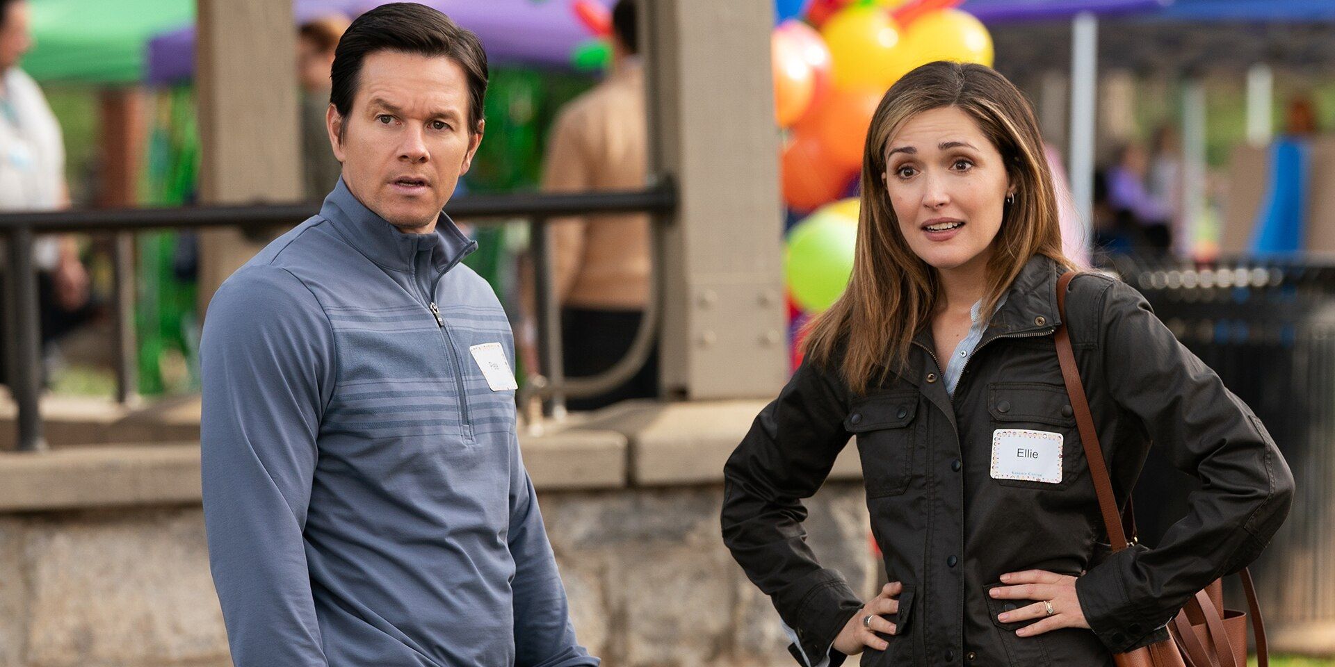 Mark Wahlberg and Rose Byrne looking off-screen in Instant Family