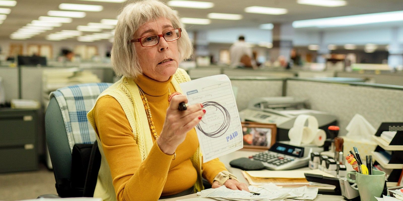 Deirdre Beaubeirdre (Jamie Lee Curtis) holds up a drawing of a circle at the IRS office in Everything Everywhere All at Once.