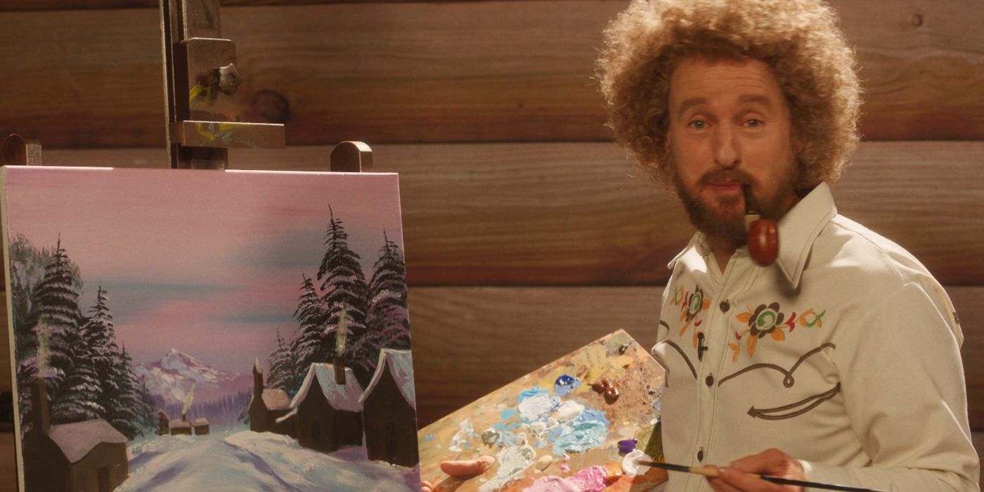 Owen Wilson as Carl Nargle with a pipe in his mouth while he paints in Paint.