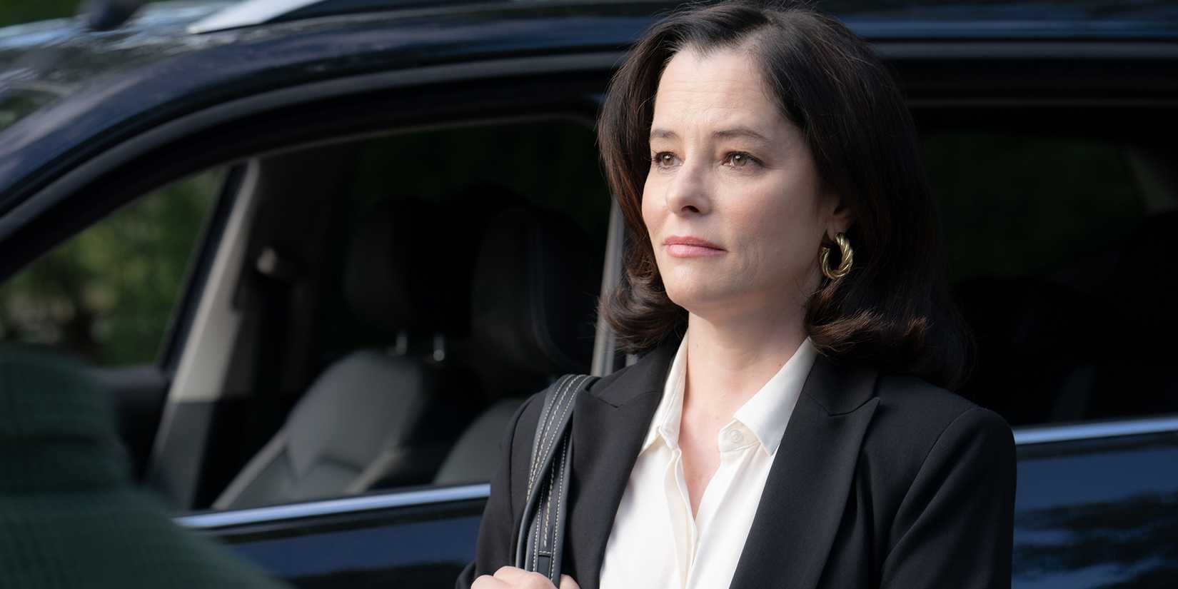 Parker Posey smiling blankly in Beau is Afraid