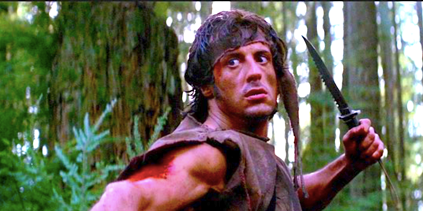 Rambo holding up a knife in First Blood