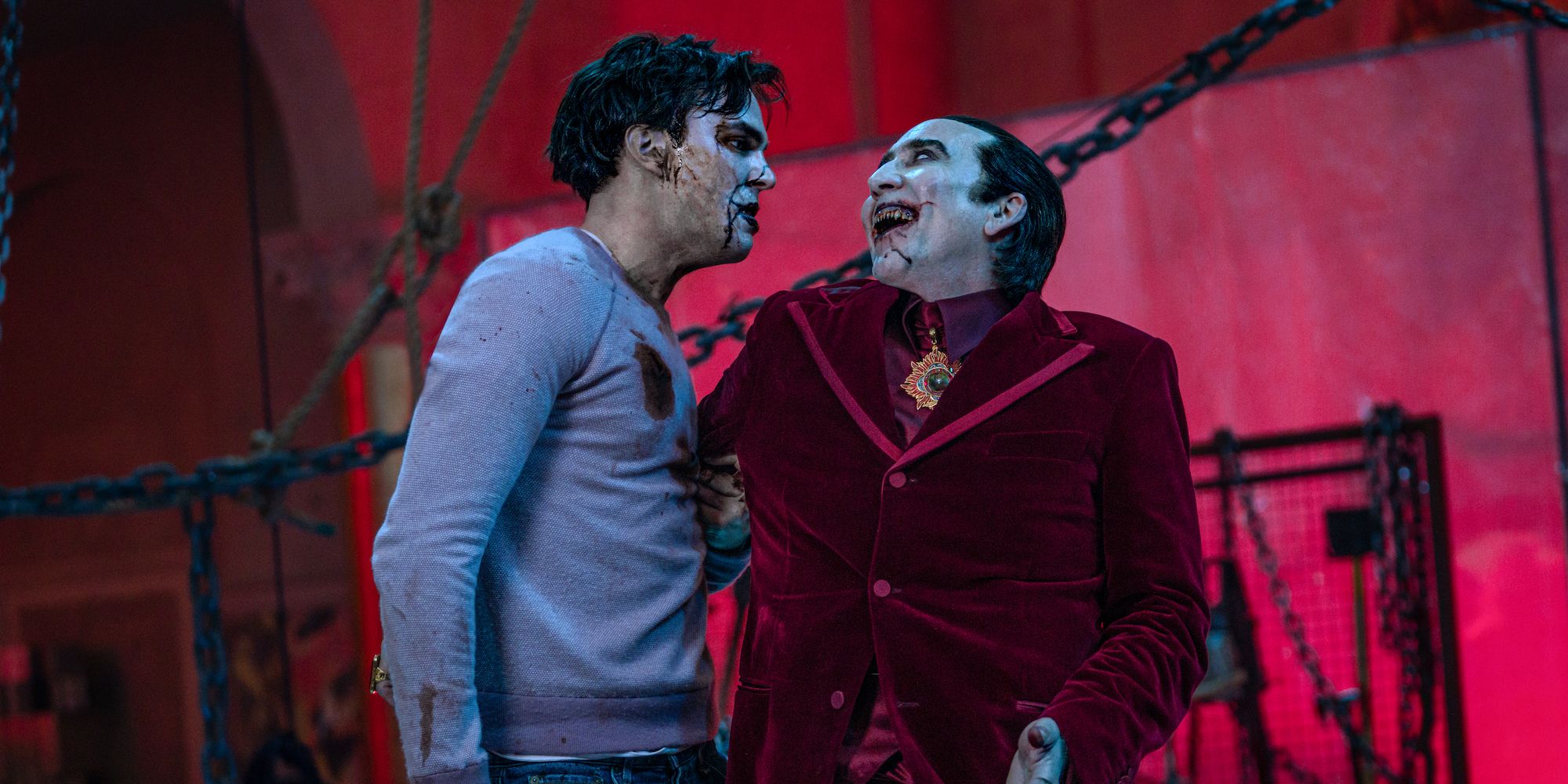 Renfield (Nicholas Hoult) looking horrified and Dracula (Nicolas Cage) laughing maniacally in Renfield
