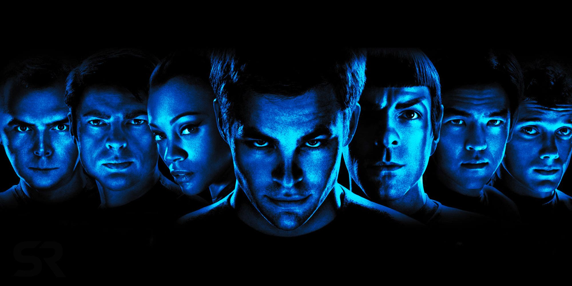 The cast of Star Trek (2009) stands together for a promotional shot on a black background with a blue filter over their faces.