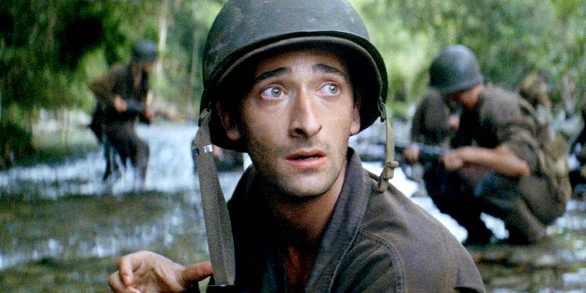 Screencap of Adrien Brody in The Thin Red Line. Brody's character is crouching fearfully in a river alongside U.S. marines.