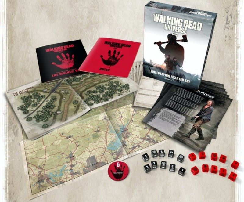 The Walking Dead Universe TTRPG Set showing dice, books, and maps.