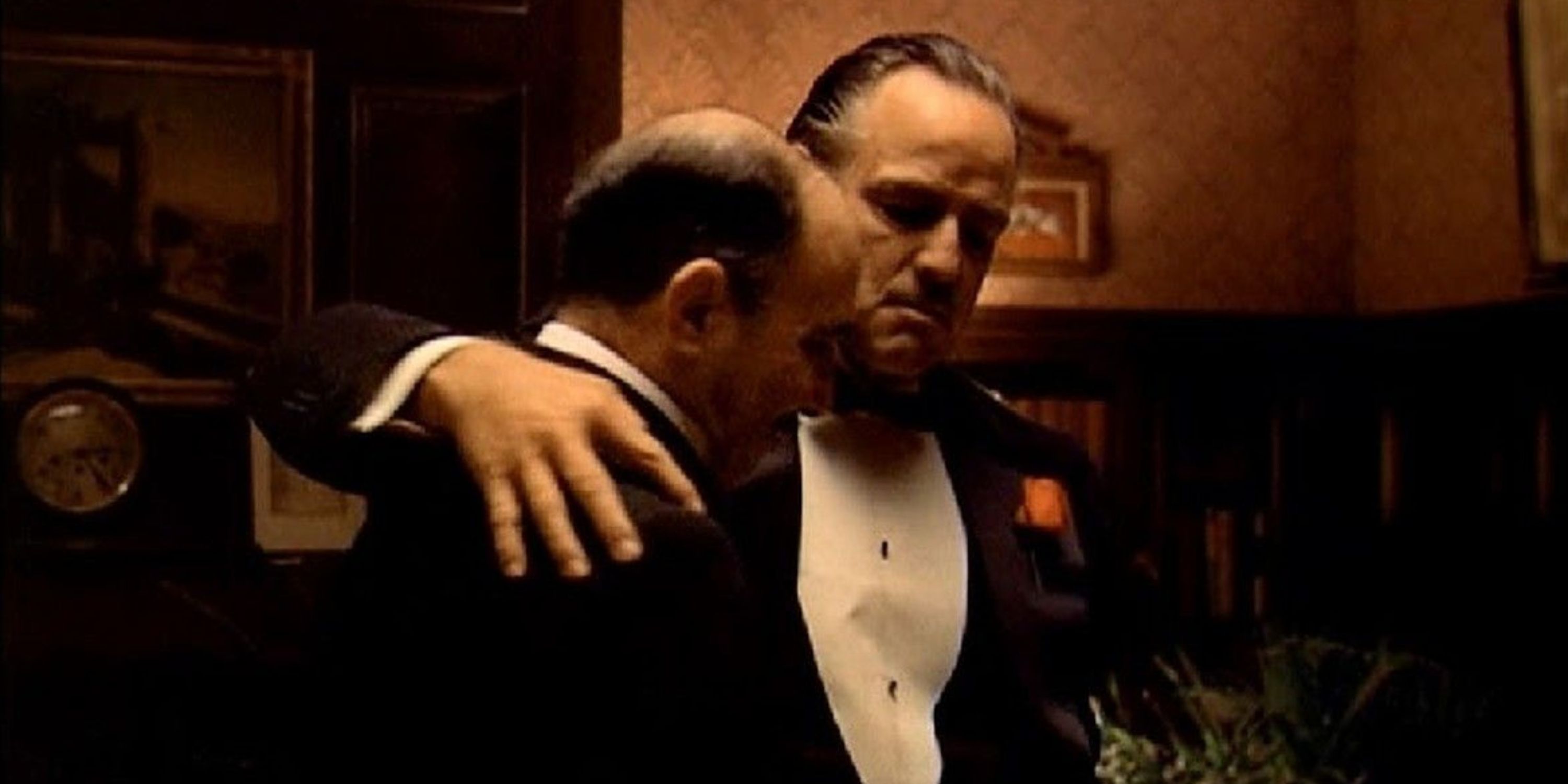 Vito Corleone with his arm around Bonasera in The Godfather