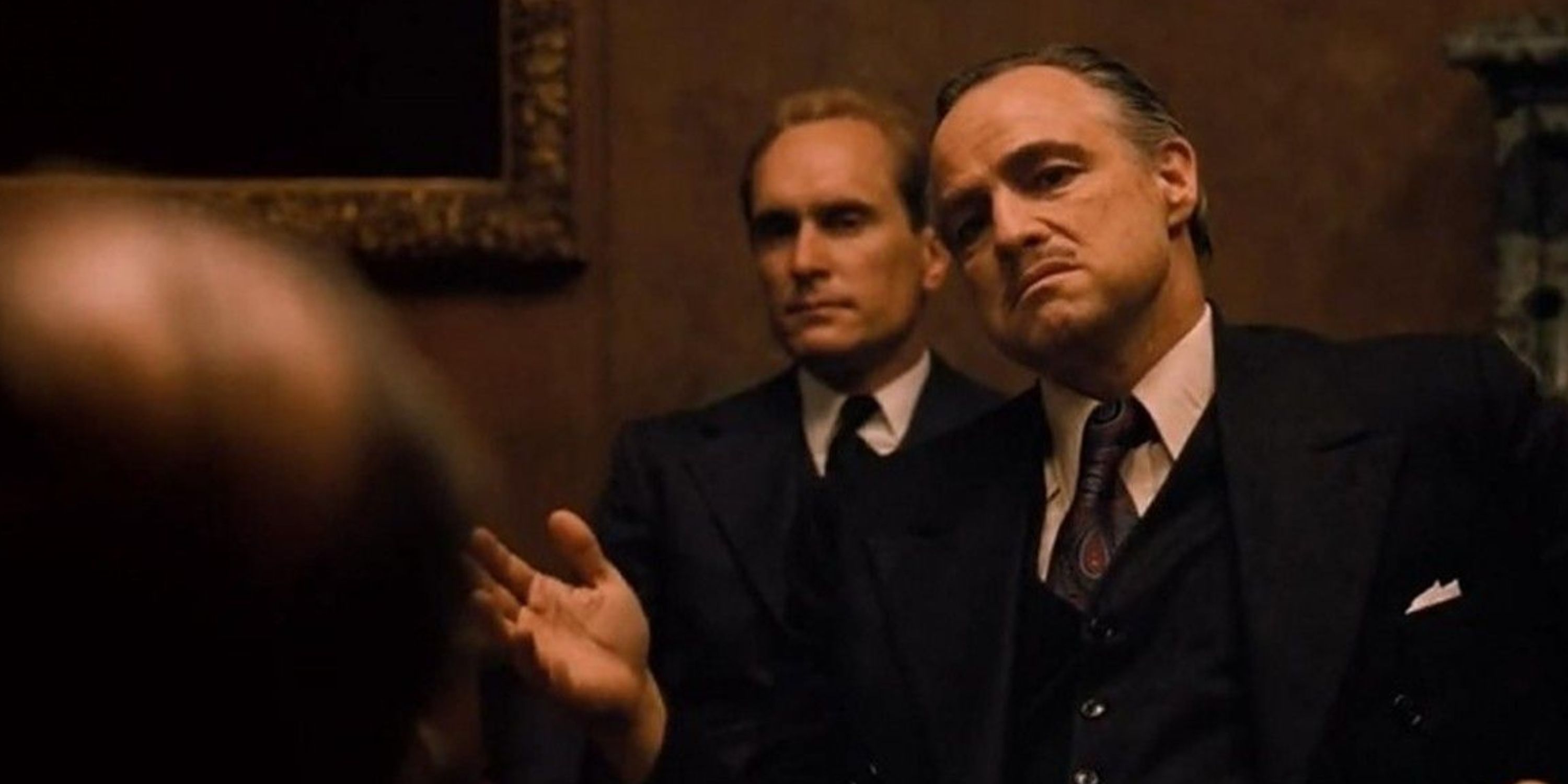 Vito Corleone with Tom Hagen meeting the bosses in The Godfather