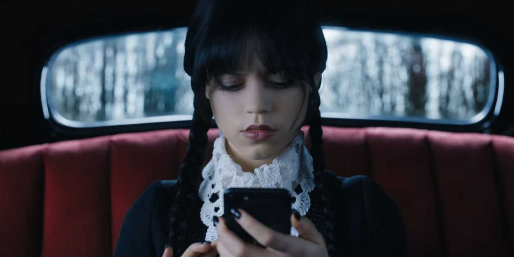 Wednesday Addams looks at texts on her phone from a stalker in Wednesday season 1 finale