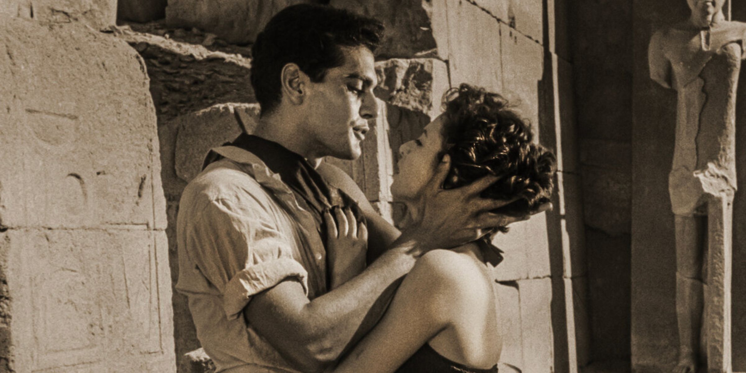 A man and woman embracing in front of Egyptian ruins in The Blazing Sun