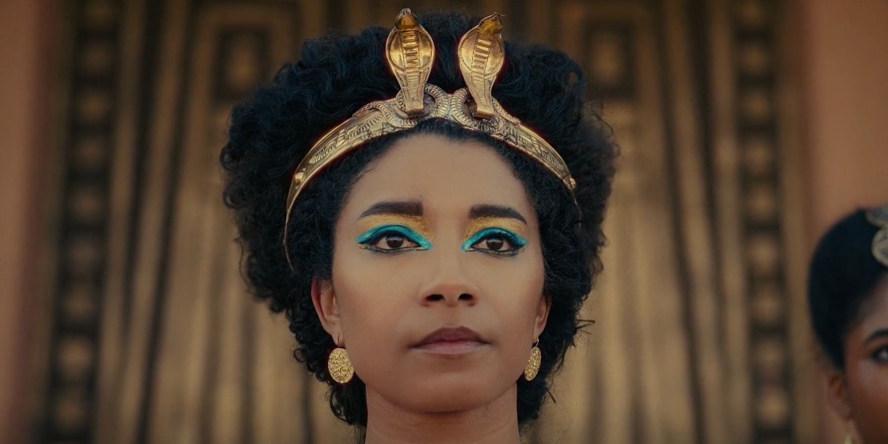 Adele James as Cleopatra looking out in Queen Cleopatra with snake crown