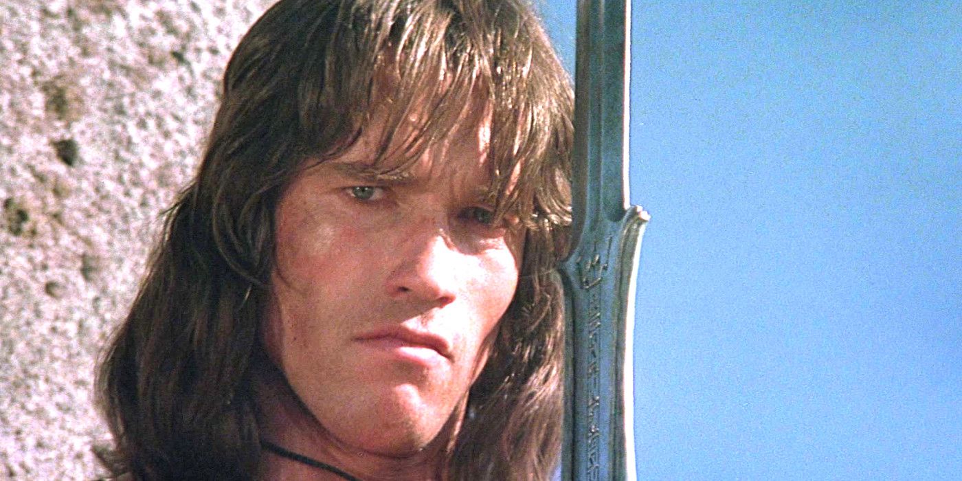 Arnold Schwarzenegger in Conan the Barbarian looking intense while holding a giant sword