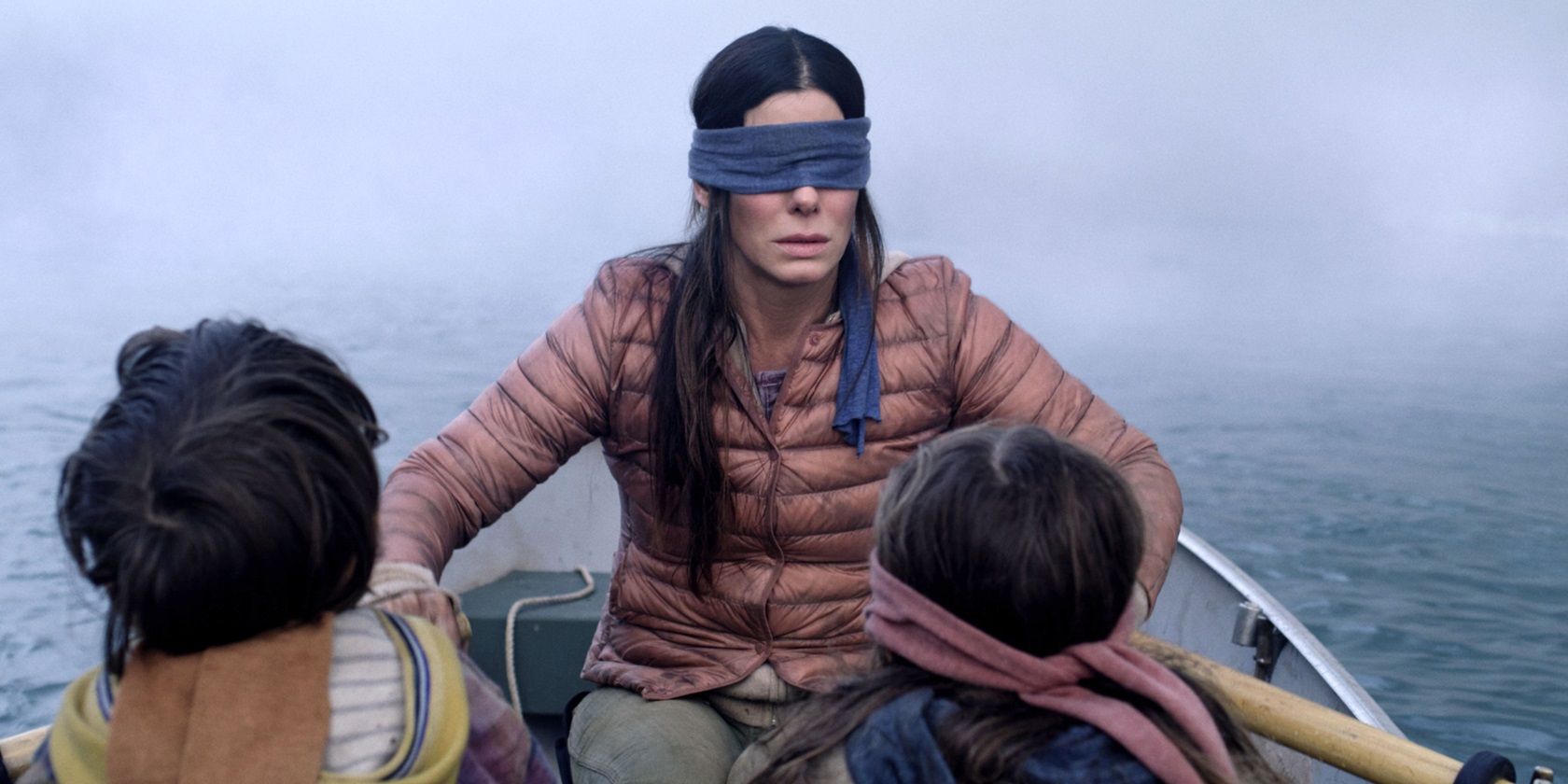 Blindfolded Sandra Bullock in a boat in Bird Box